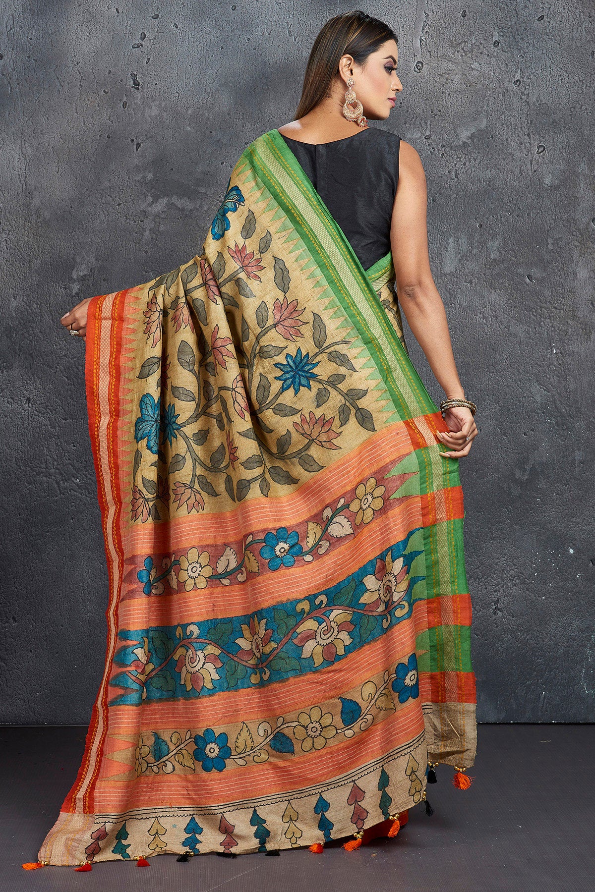 Buy beautiful pen Kalamkari saree online in USA with orange and green border. Keep your ethnic wardrobe up to date with latest designer sarees, pure silk sarees, Kanchipuram silk sarees, handwoven sarees, tussar silk sarees, embroidered sarees from Pure Elegance Indian saree store in USA.-back