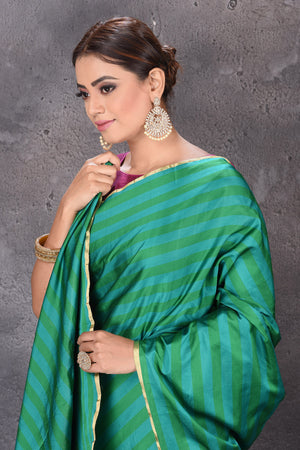 Buy stunning dark and light green stripes Mashru silk saree online in USA. Keep your ethnic wardrobe up to date with latest designer sarees, pure silk sarees, handwoven sarees, tussar silk sarees, embroidered sarees from Pure Elegance Indian saree store in USA.-closeup