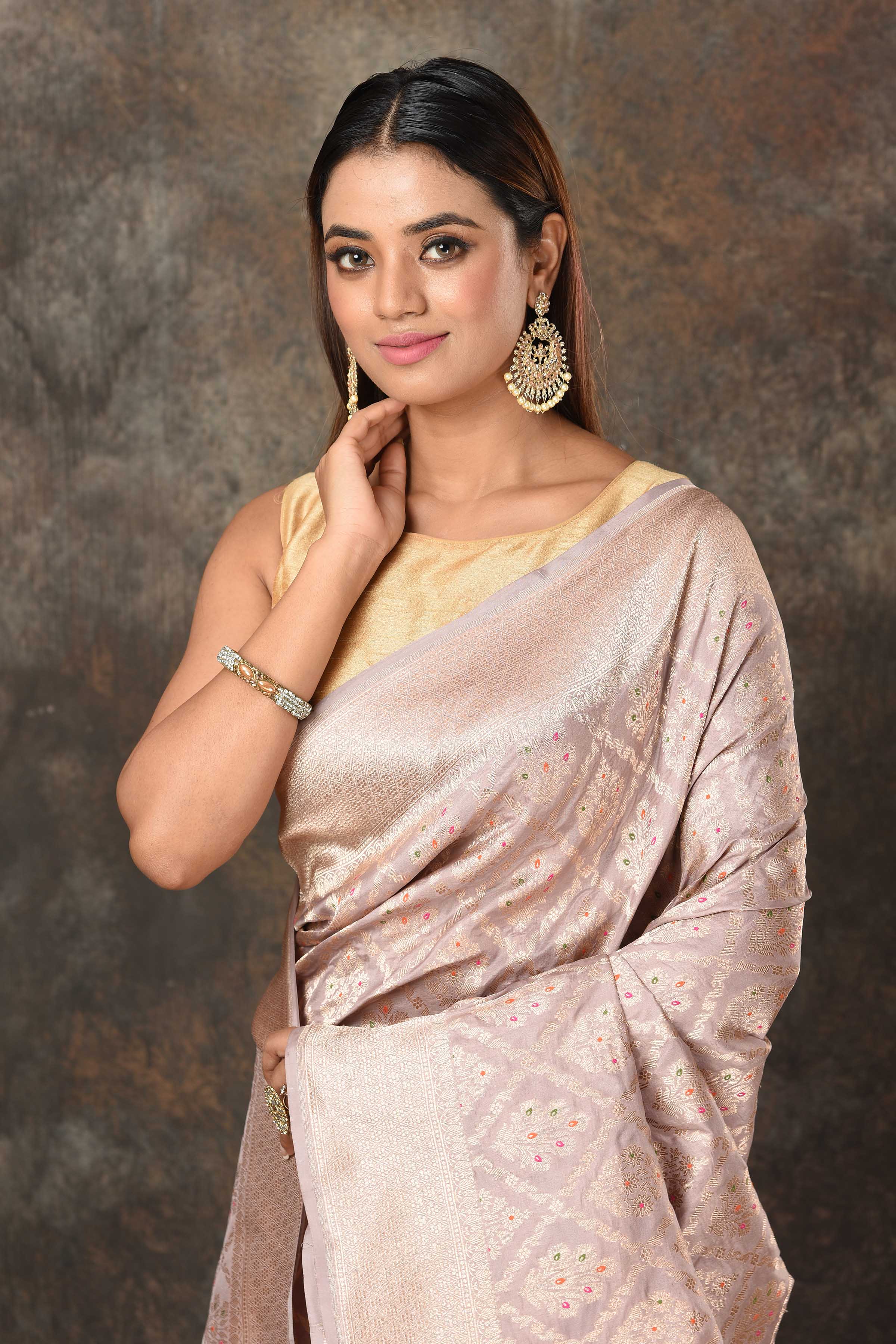 Shop light grey Banarasi sari online in USA with silver minakari zari work. Look royal at weddings and festive occasions in exquisite Banarasi saris, handwoven sarees, tussar silk sarees, Bollywood sarees, partywear sarees from Pure Elegance Indian saree store in USA.-closeup