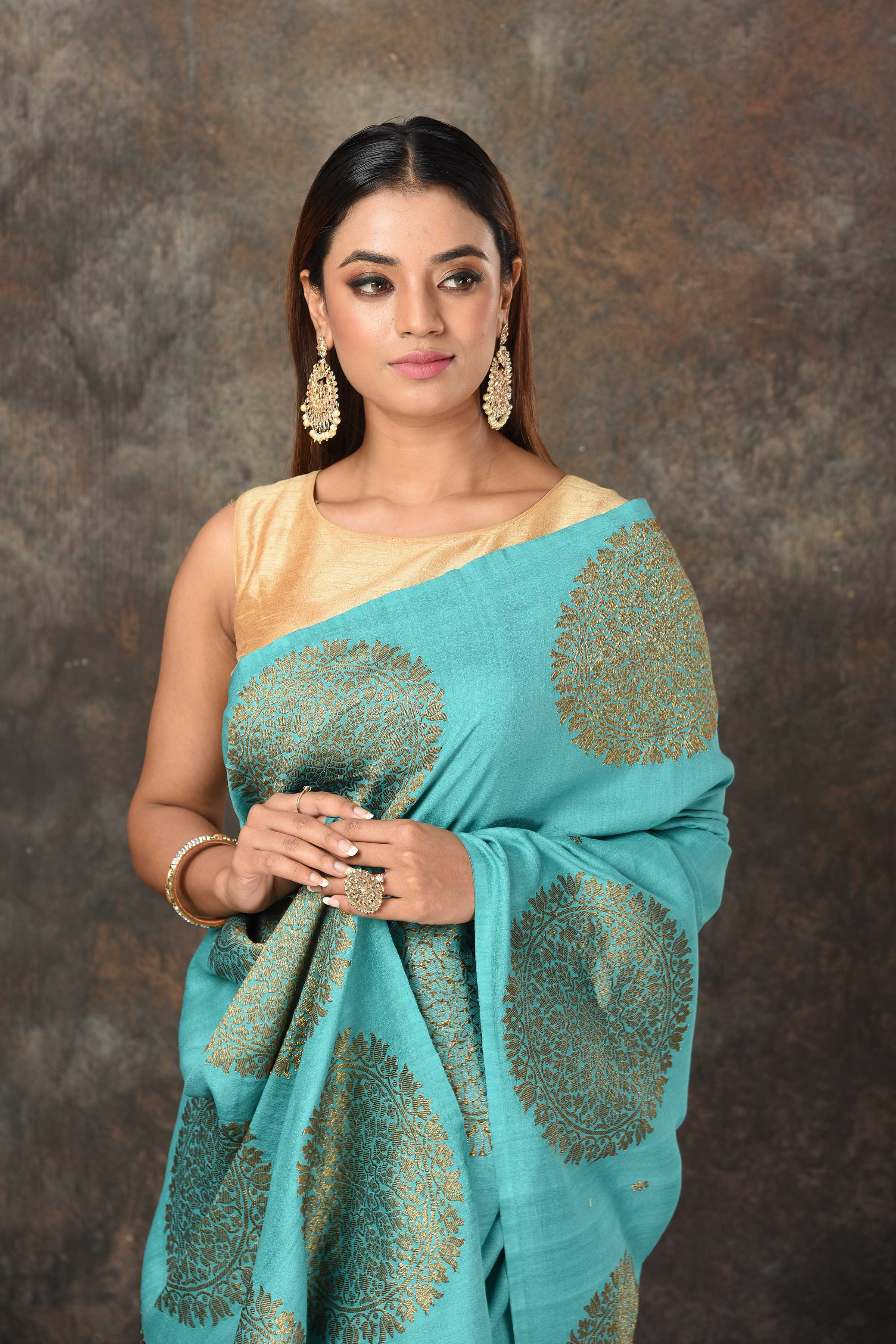 Buy sea green Benarasi sari online in USA with antique zari motifs. Look royal at weddings and festive occasions in exquisite Banarasi saris, handwoven sarees, tussar silk sarees, Bollywood sarees, partywear sarees from Pure Elegance Indian saree store in USA.-closeup