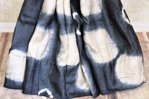 Buy stunning black and cream shibori print tussar silk saree online in USA. Look elegant on special occasions in beautiful printed sarees, silk sarees, tussar sarees, handloom sarees, Kanchipuram sarees from Pure Elegance Indian saree store in USA.-pleats