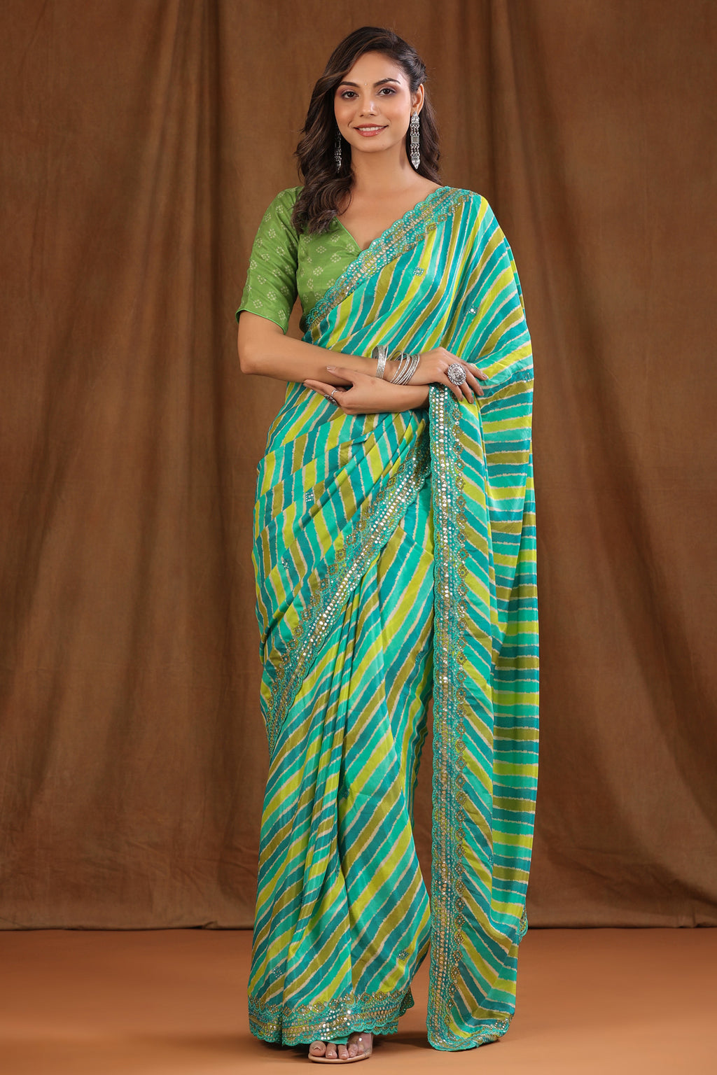 Buy green stripes crepe sari online in USA with scalloped border. Make a fashion statement at weddings with stunning designer sarees, embroidered sarees with blouse, wedding sarees, handloom sarees from Pure Elegance Indian fashion store in USA.-full view