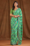 Buy green stripes crepe sari online in USA with scalloped border. Make a fashion statement at weddings with stunning designer sarees, embroidered sarees with blouse, wedding sarees, handloom sarees from Pure Elegance Indian fashion store in USA.-full view