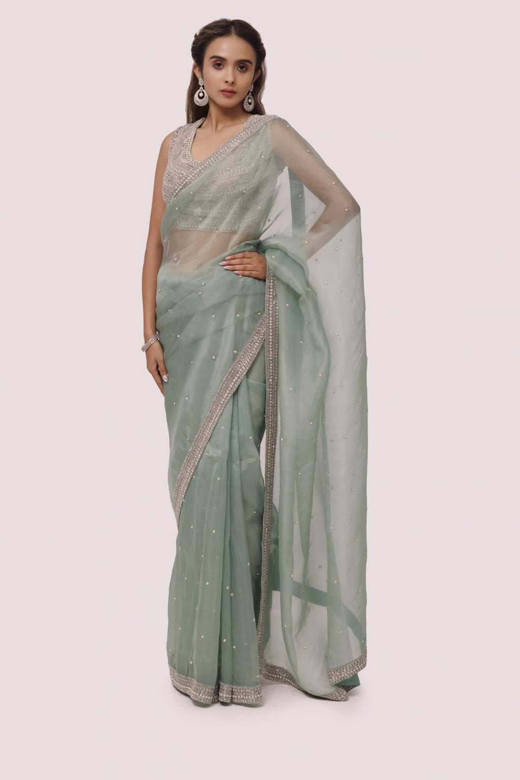 Shop an alluring green organza saree featuring cut Dana work on the blouse and saree border detailing is a perfect choice for parties! It comes with a designer saree blouse. Make a fashion statement at weddings with stunning designer sarees, embroidered sarees with blouses, wedding sarees, and handloom sarees from Pure Elegance Indian fashion store in the USA.