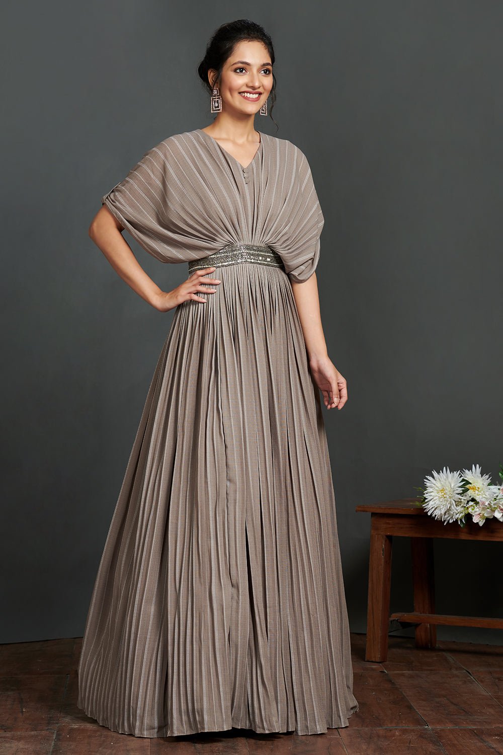 Buy beautiful grey pleated gown online in USA with metallic belt. Make a fashion statement on festive occasions and weddings with designer suits, Indian dresses, Anarkali suits, palazzo suits, designer gowns, sharara suits from Pure Elegance Indian fashion store in USA.-right