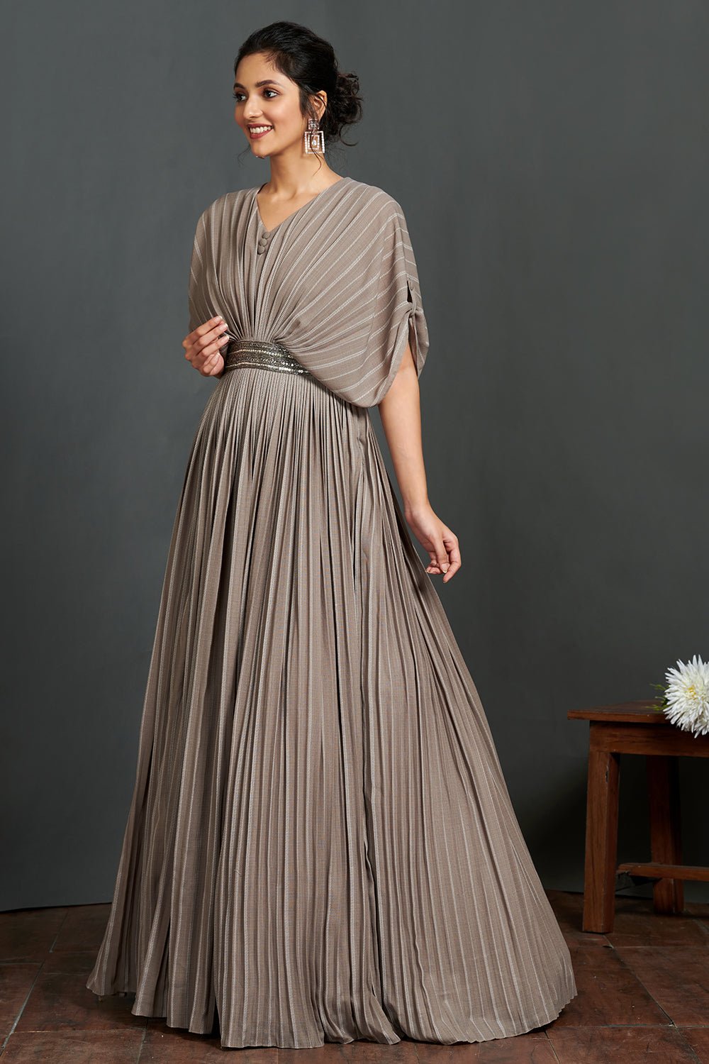 Buy beautiful grey pleated gown online in USA with metallic belt. Make a fashion statement on festive occasions and weddings with designer suits, Indian dresses, Anarkali suits, palazzo suits, designer gowns, sharara suits from Pure Elegance Indian fashion store in USA.-left